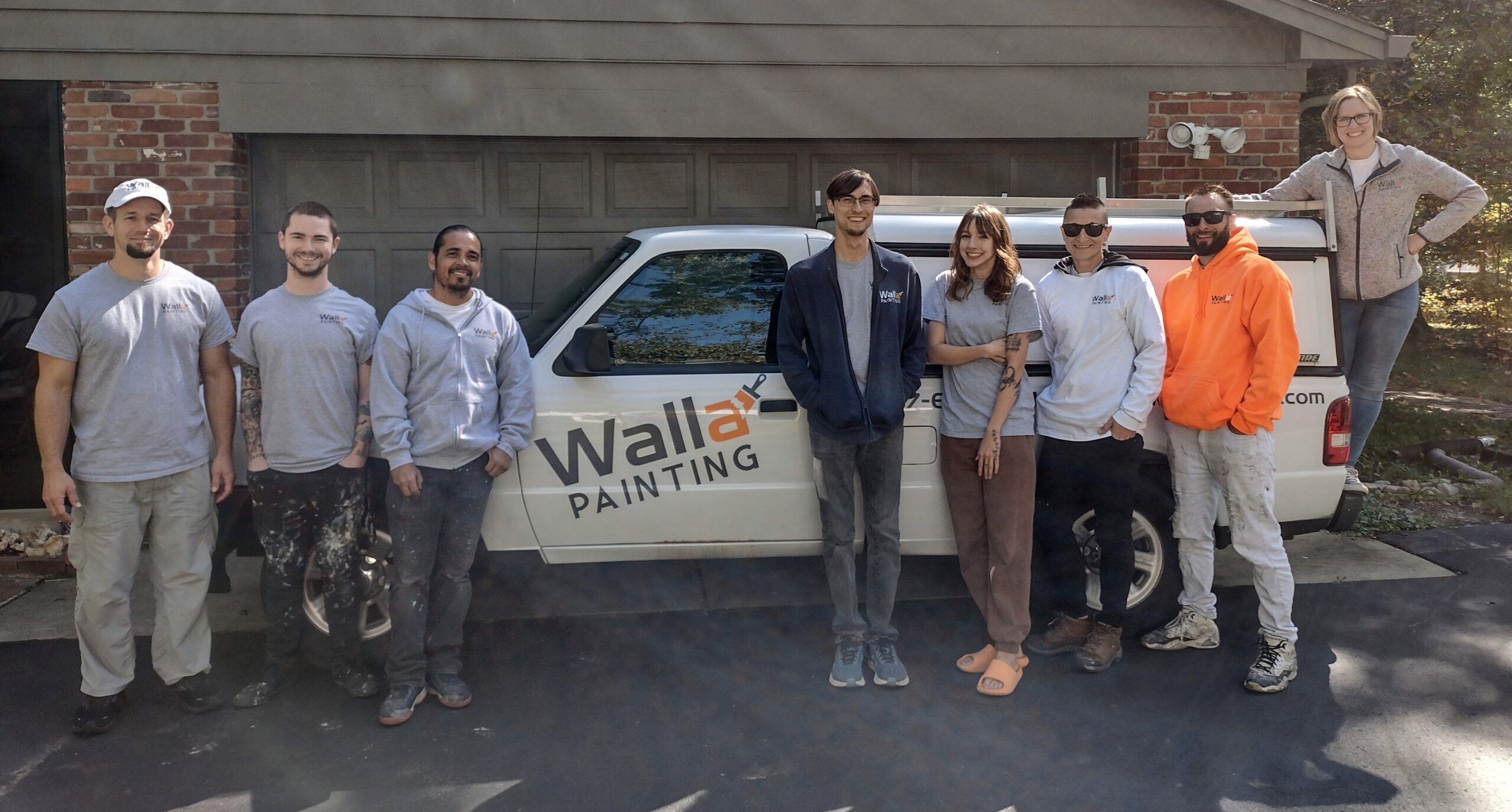 walla painting membes in front of truck
