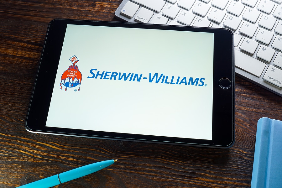 Image of Sherwin-Williams brand logo on the screen of a tablet sitting on a professional desk.